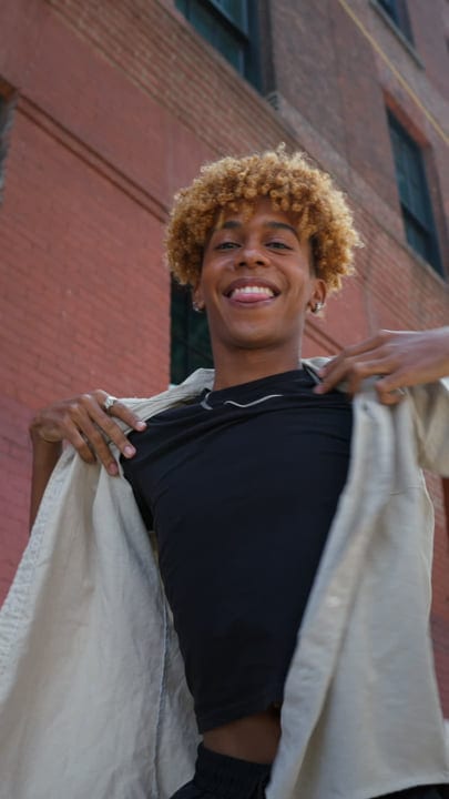 Youthful Expression Unfolds Against Urban Brick Backdrop