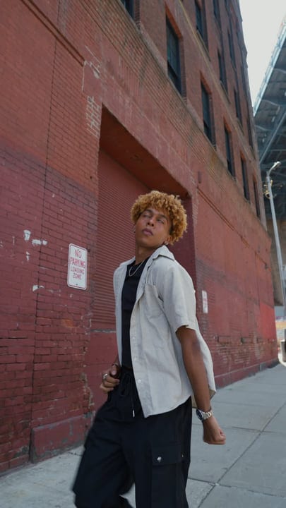 Youthful Confidence Against A Backdrop Of Urban Brick