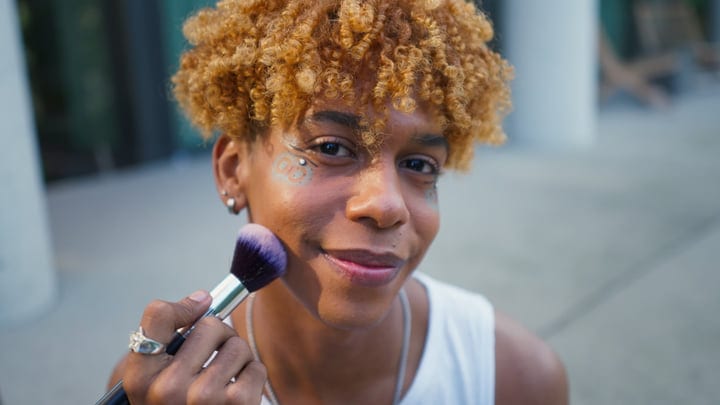 Joyful Expression With Makeup Brush On City Street