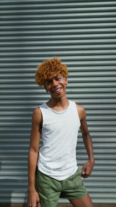 Sunlit Smiles Captured Against Urban Metal Backdrop