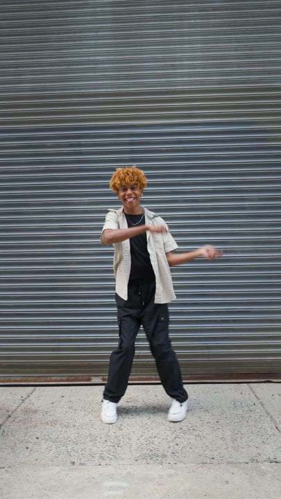 Energetic Youth Dancing Against Urban Backdrop