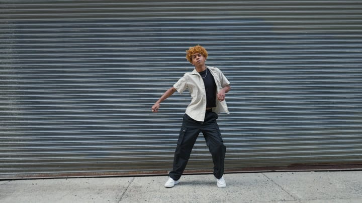 Young Dancer Moves Freely Against Urban Backdrop