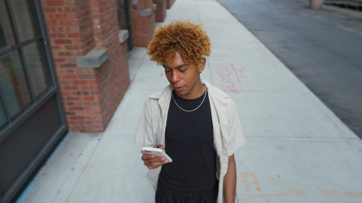 Young Urban Explorer Engages With Technology On The Go