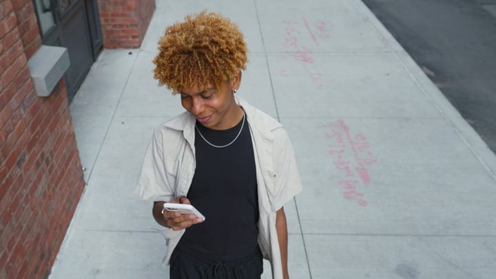 Young City Dweller Engages With Technology On The Go
