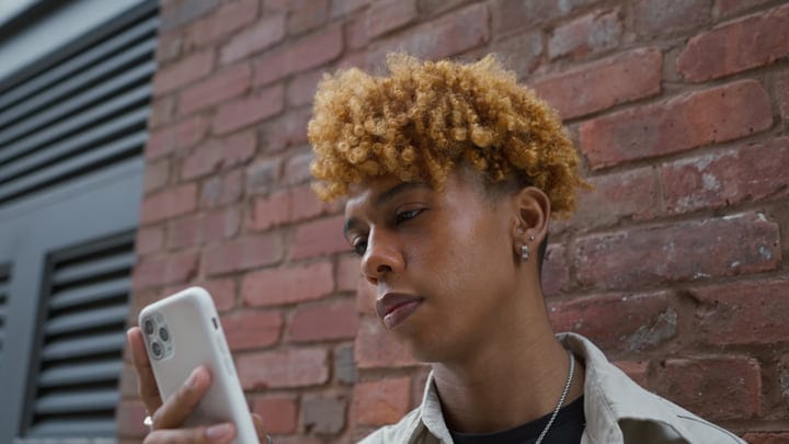 Youthful Connection Against A Brick Wall In NYC