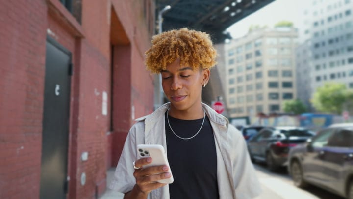 Youth Engages With City Vibes Through His Phone