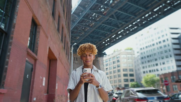 Youth Engages With Technology Under Urban Bridge