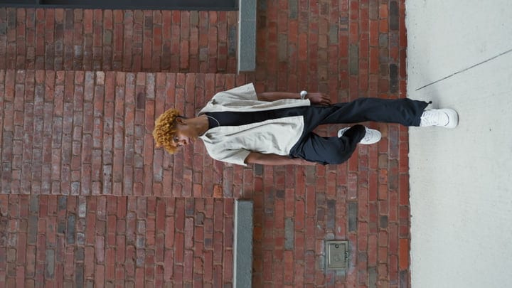 Youthful Contemplation Against The Urban Brick Canvas