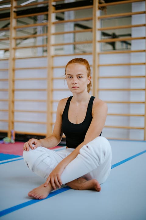 Focused Woman Meditates Before Intense Parkour Session