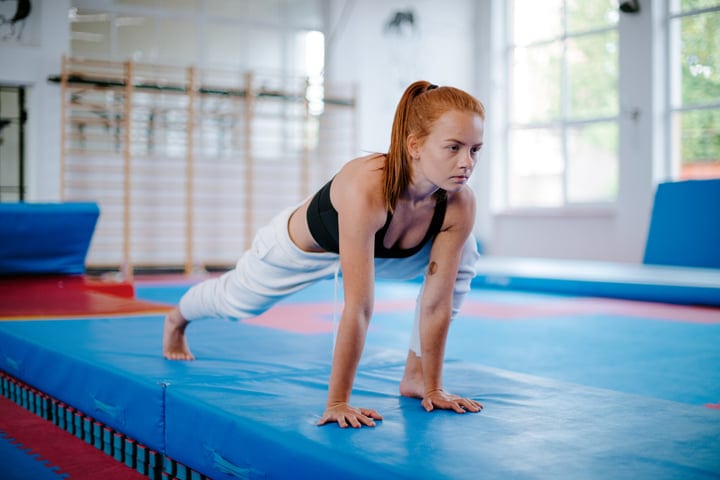 Focused Woman Embracing Strength During Parkour Training