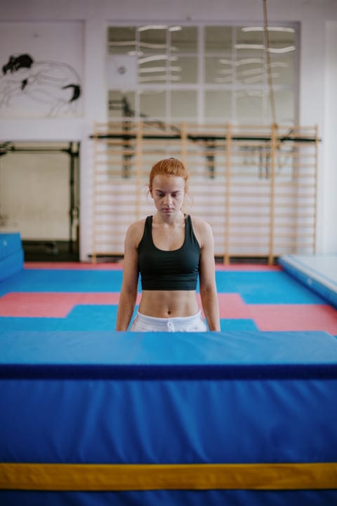 Focused Woman Prepares For Intense Parkour Challenge Indoors