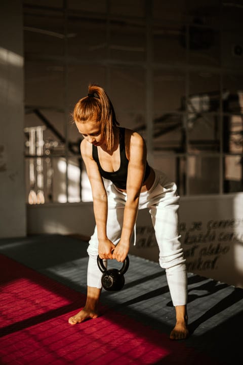 Focused Woman Balances Strength and Grace in Training