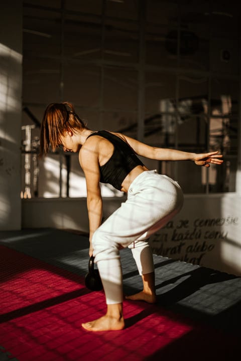 Graceful Balance: Woman Engaged In Dynamic Parkour Training