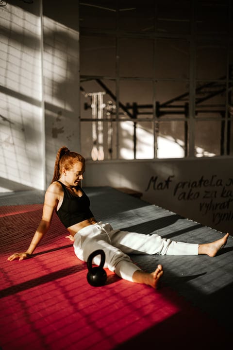 Morning Sunlight Illuminates A Woman Resting After Parkour