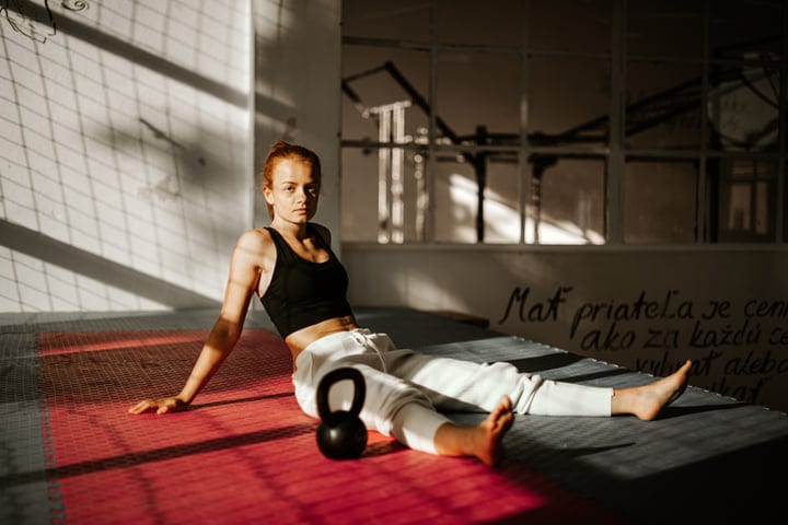 Sunlit Strength: Woman Pausing From Parkour Training