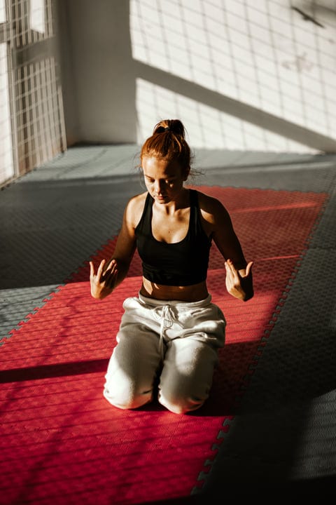 Sunlit Serenity: Woman Meditating After Parkour Training