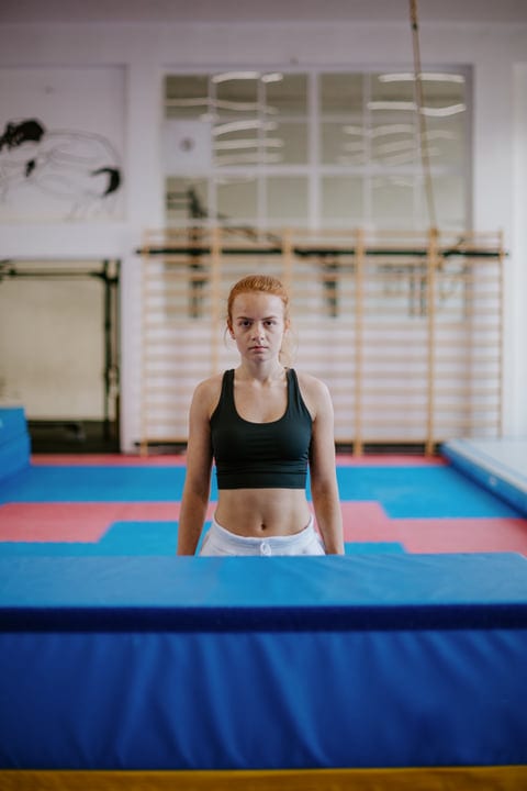 Fierce Focus of Woman Preparing for Parkour Challenge