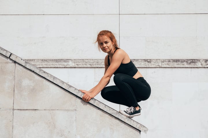 Woman Embraces The Challenge Of Urban Parkour Adventure