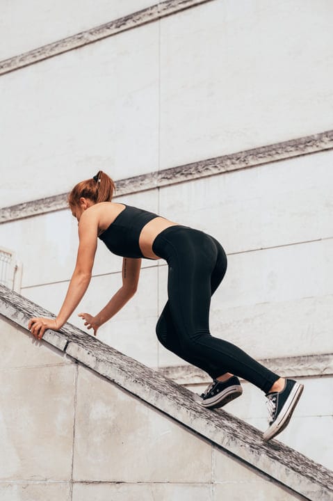 Dynamic Woman Scaling Urban Architecture With Graceful Ease