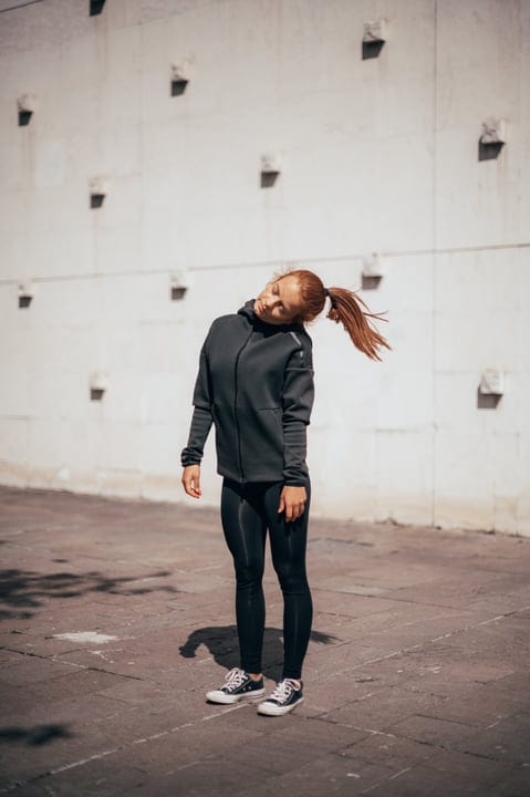 Young Woman Embraces Urban Parkour Spirit In Sunlit Scene