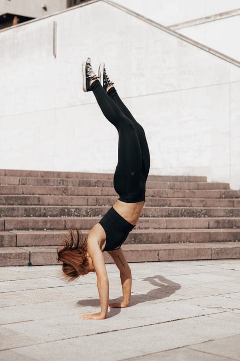 Urban Elegance As Woman Executes Perfect Handstand