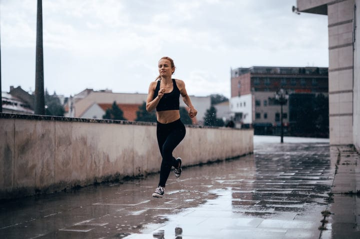 Fearless Woman Conquers Rainy Urban Landscape With Parkour