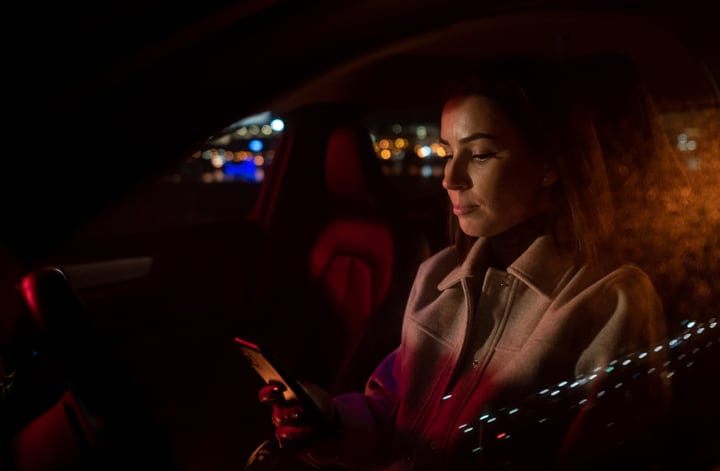 A Businesswoman Navigates The Night With Focused Determination