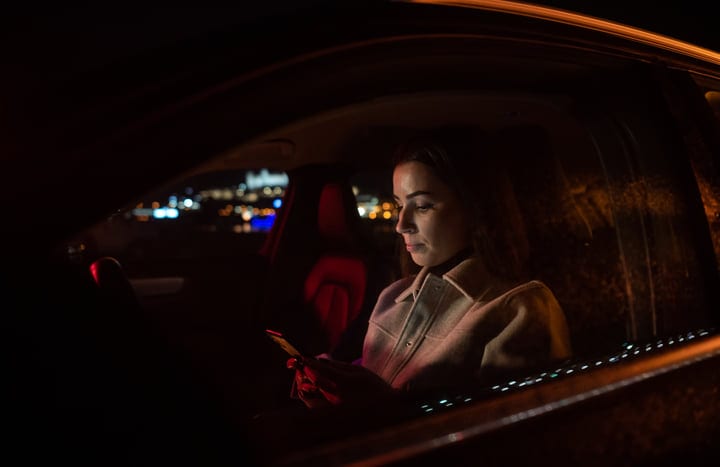 A Businesswoman Navigates The Night With Focused Intensity