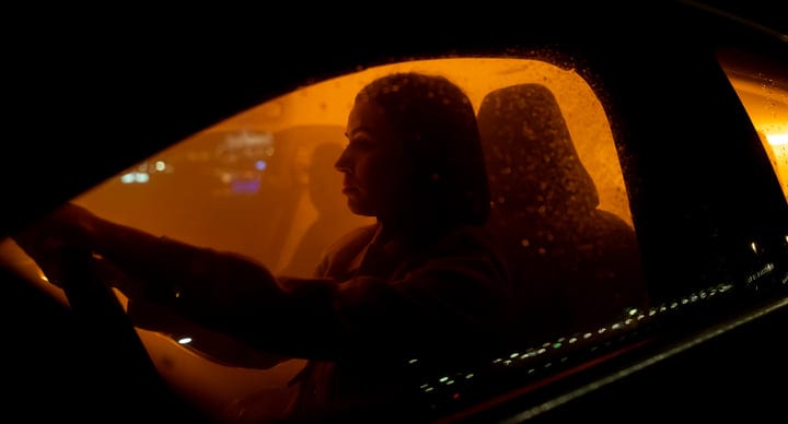 A Businesswoman Navigates Through Night In The City