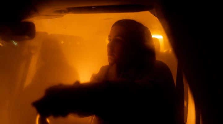 A Businesswoman Navigates the City Lights at Night