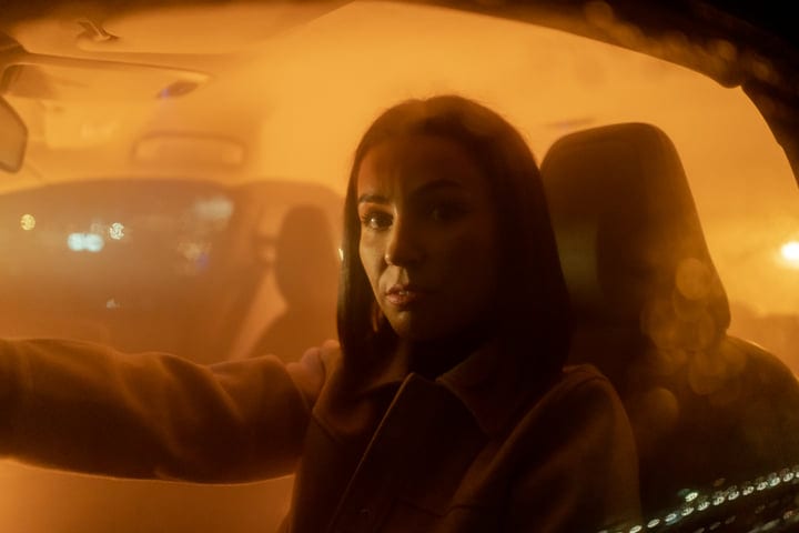 A Businesswoman Navigates the Night Roads with Focus