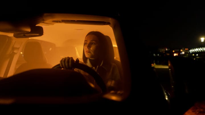 Focused Businesswoman Navigates the Quiet Nighttime Streets
