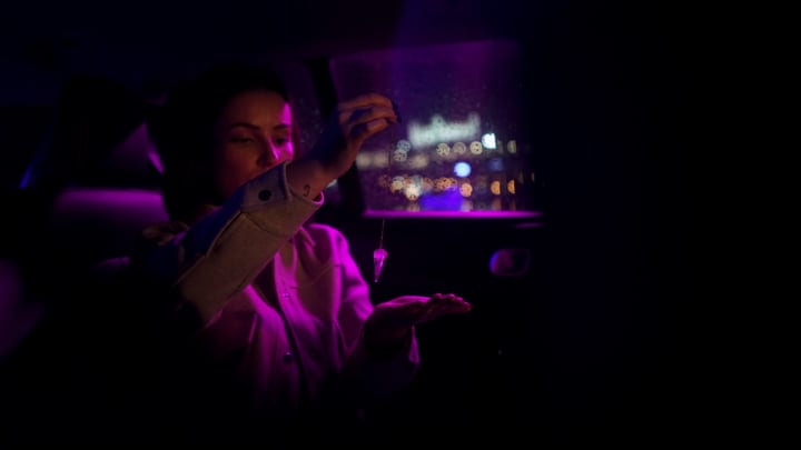 Businesswoman Navigates Nightscape With Poise And Precision