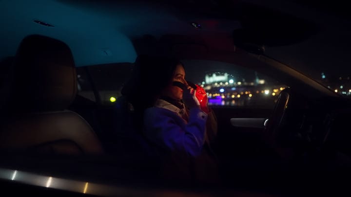 A Businesswoman Reflects During Her Evening City Drive
