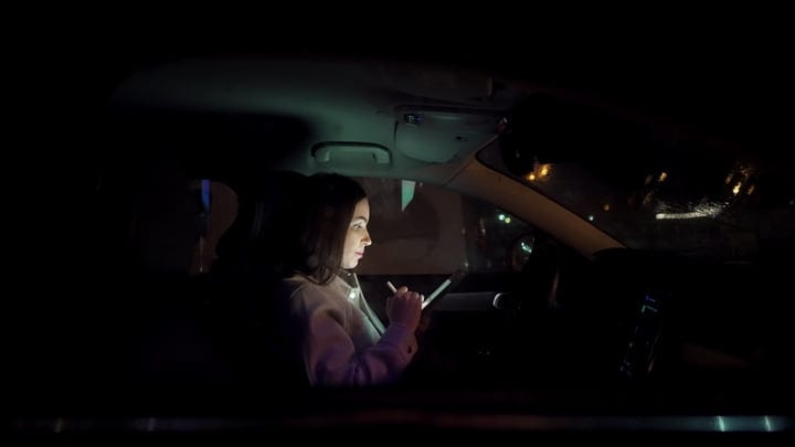 Focused Businesswoman Navigates Night Streets With Determination
