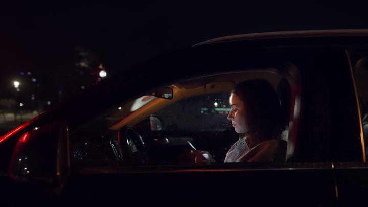 Focused Businesswoman Navigates City Streets At Night