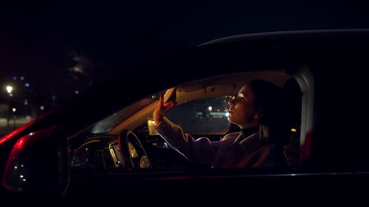 A Businesswoman Navigates The Night In Her Car