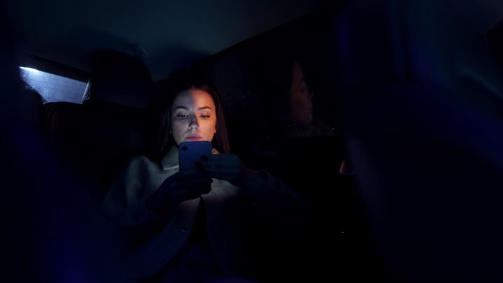 Focused Businesswoman Navigates Night Drive with Determination