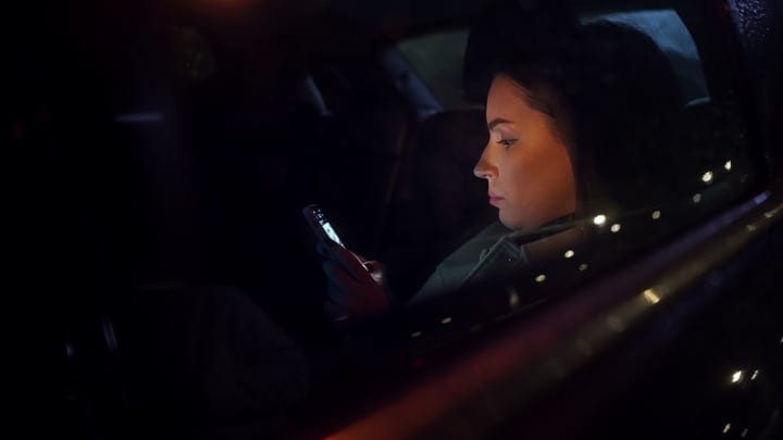 Focused Businesswoman Navigates Night Streets With Determination