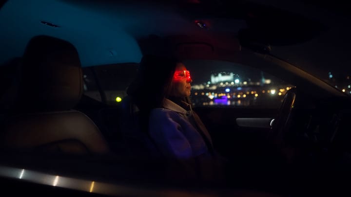 Night Drive: Businesswoman Navigates City Lights in Style