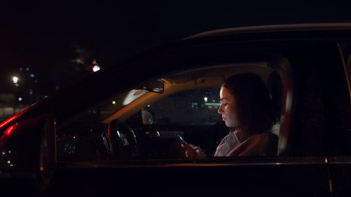 Businesswoman Navigates Night City Streets with Confidence