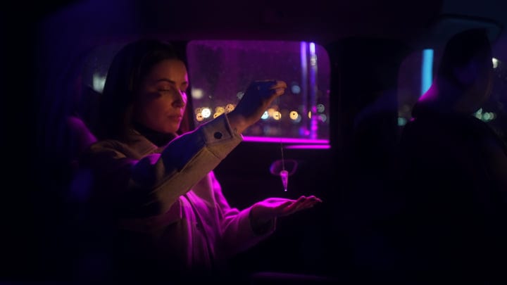 Businesswoman Contemplates in a Neon-Lit Night Car Ride