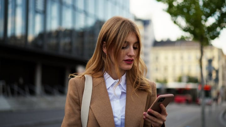 Businesswoman Checking Her Phone in Vienna's Urban Heart