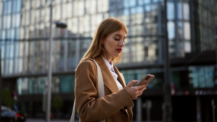 Young Professional Checks Her Phone In Vienna's Buzz