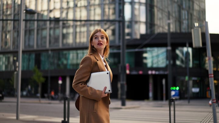 Confident Businesswoman Walks Through Vienna's Morning Light