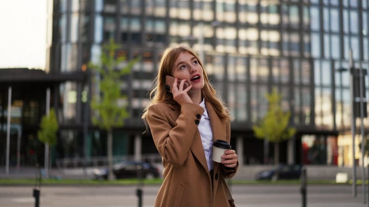 Businesswoman Engages in Call Outside Vienna Cafe
