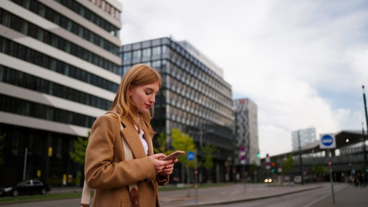Businesswoman Engaged With Smartphone On Vienna Street