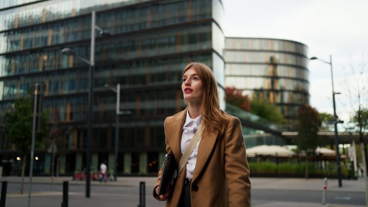 Confident Businesswoman Striding Through Modern Vienna Streets