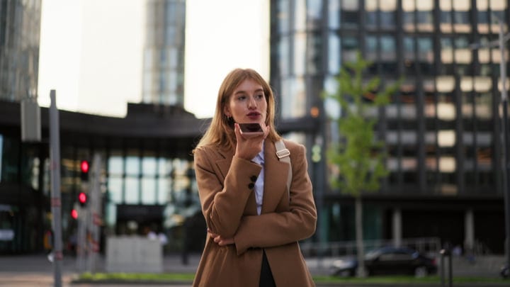 Confident Businesswoman Dictates Notes In Vienna's Urban Pulse
