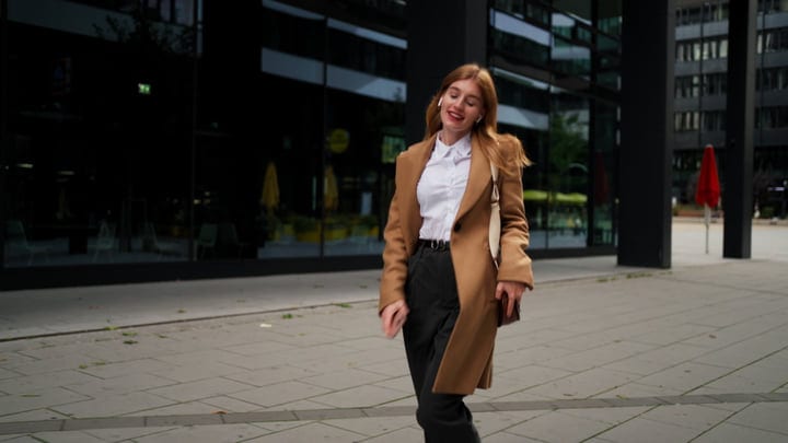 Confident Businesswoman Strolling Through Modern Vienna Street